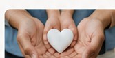 Hands holding a heart symbol
